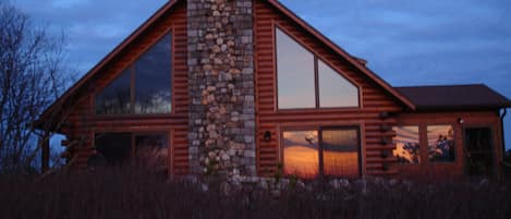 Sunset reflected in the expansive windows facing Shank Painter pond.