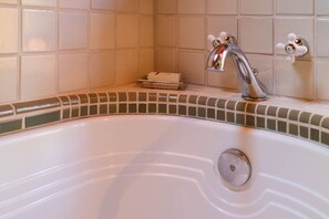 Hand-tiled trim around the tub