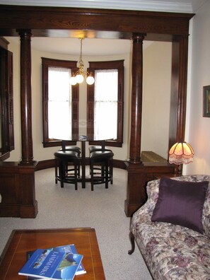 A look towards the front room with a glass gaming table. 