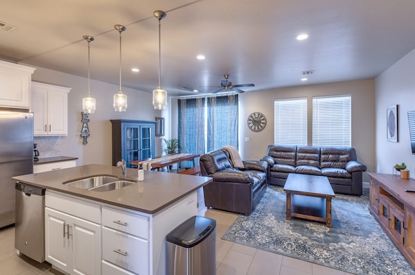 Living Room View - The living room is designed as an open floor plan and is a great gathering place for meals, games, or watching TV during your stay.