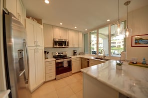 Granite countertops with a large pass through window to the lanai 