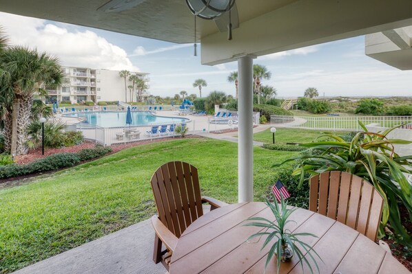 Patio - Patio features a table with seating for four and an electric grill for outdoor barbequing. Just steps away from the pool and beach walk