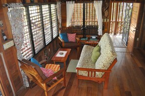 Beachfront Blue Moon Cabana. Open floor plan and surrounded by windows.