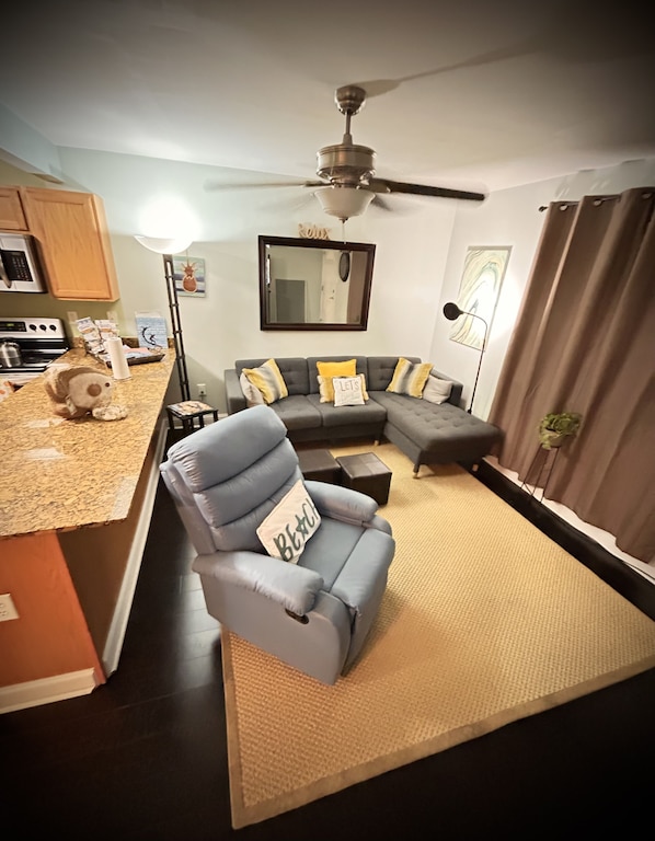 Leather swivel rocker recliner and cozy sectional for relaxing after a long day.