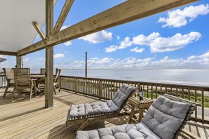 Loungers on the deck make for the perfect relaxation spot. Would you rather sunbathe or read a book with the waves as your soundtrack?