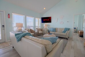 Kick back in the bright and inviting living room, complete with comfortable seating and Roku for streaming.