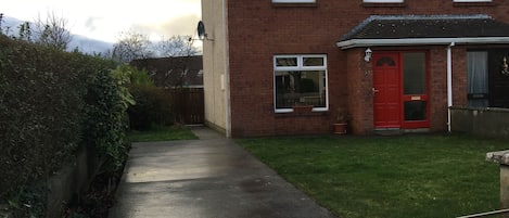 House front, driveway and garden