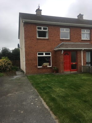 House front, driveway and garden