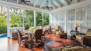 The covered lanai has a large outdoor TV and comfy outdoor furniture...
