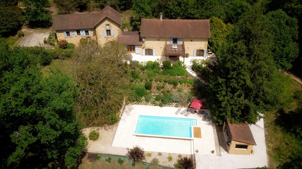 East and west wings of the house, pool, gardens and pool house.