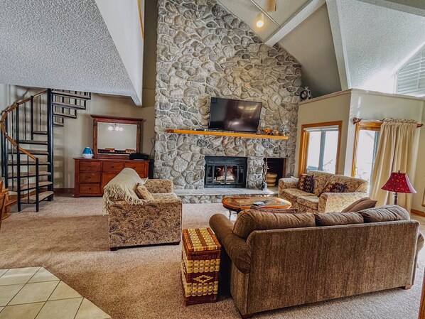 living room with wood burning fireplace