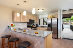 Kitchen with bar seating at our Kona VIlla