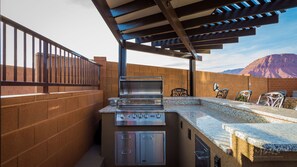 Outdoor BBQ kitchen with covered pergola. 