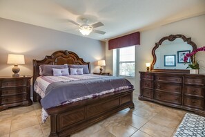 This bedroom, adorned with wooden details and accents, radiates warmth and serenity, inviting you to unwind in a cozy retreat where nature's embrace meets modern comfort.