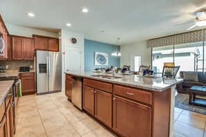 The kitchen with its coveted bar counter becomes a central gathering place, where culinary creations meet lively conversations, fostering connections and culinary adventures alike.