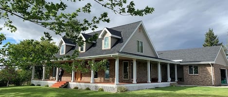 The home features a 20-acre private property with a combination of horse pasture, cottonwood and pine trees, and meadows.