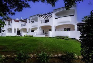 Rear of apartment with garden, facing indoor pool