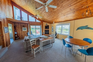 Family room with vaulted ceilings and custom windows.