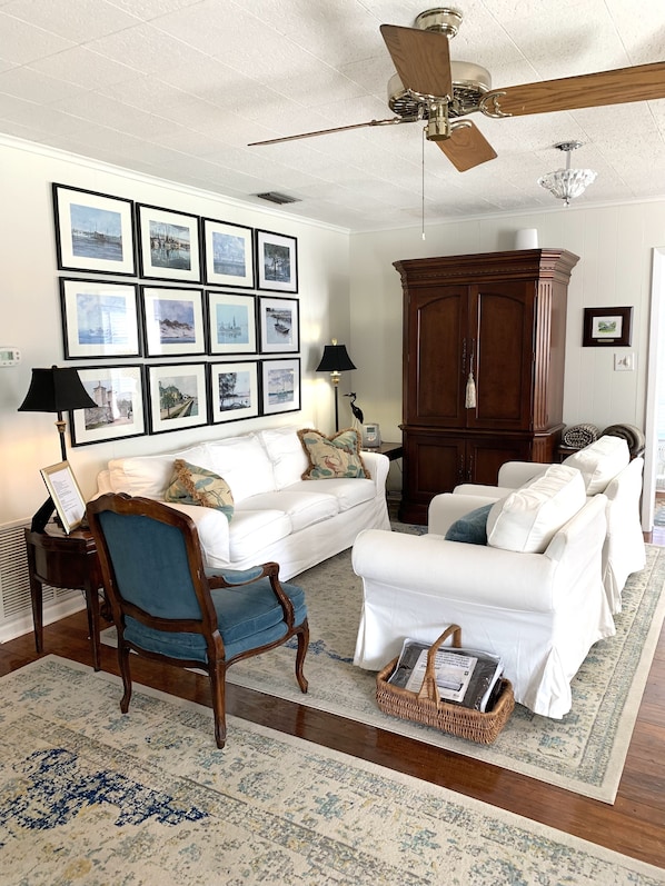 Living room with comfortable seating for 4, streaming TV and lots of DVDs.