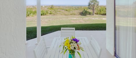 Patio - Oceanfront patio features a table with seating for six and an electric grill for outdoor barbequing. Perfect spot to relax and unwind!