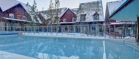 year round outdoor heated pool with hot tub at the entrance