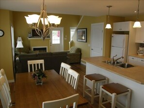 Cottage interior with dining room opened to living room area.