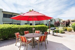 Covered patio seating, gas BBQ's, and beautifully landscaped lawns