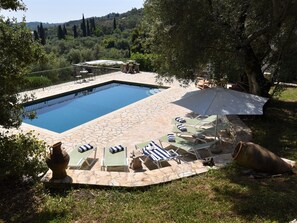 Large amounts of space with sun or shade around Villa Loukia's pool!