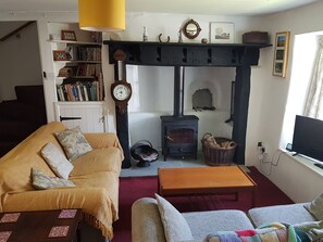 The sitting room has a wood burner and smart TV