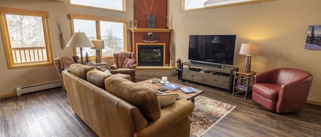 Great Room with high celings, large windows & fireplace. 65" TV and Sonos system