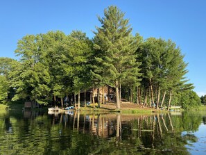 House built on peninsula surrounded by water on 3 sides