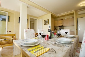 The dining area and the living room, with the open kitchen at the back