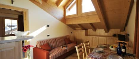 Open plan living room and kitchen with dining area