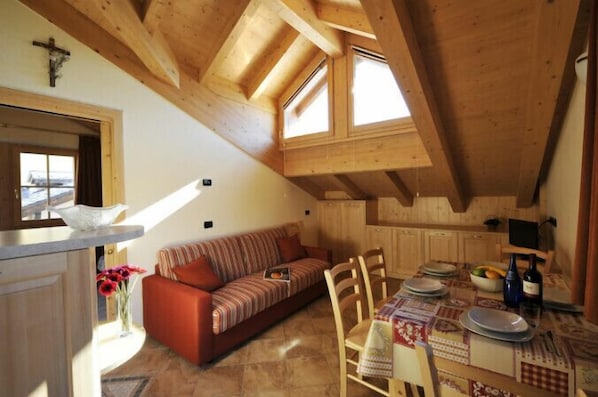 Open plan living room and kitchen with dining area