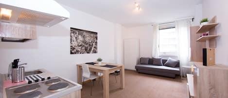 Open plan living room with sofa double bed