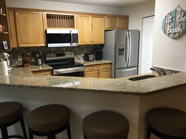 Kitchen - Granite counter with 4 bar stools
