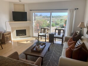 Living room opens up to the garden and preserve beyond.