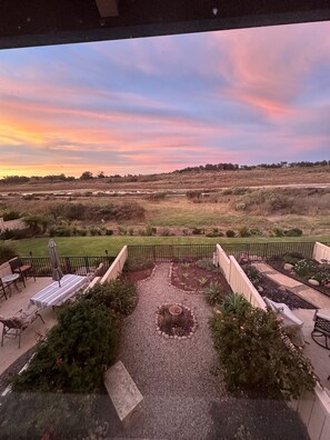 Beautiful backyard with a dining table and bench that overlooks the Elwood Mesa.