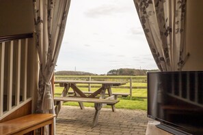 View from living area out to patio, garden and farmland. 