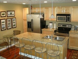 Kitchen with Stainless Steel Appliances & Granite Countertops.