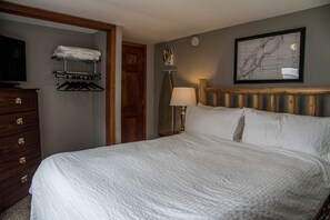 Iron and ironing board located in bedroom