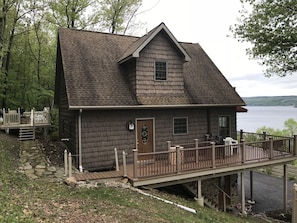 Corner view showing the wrap around balcony and the upper patio and fire pit.