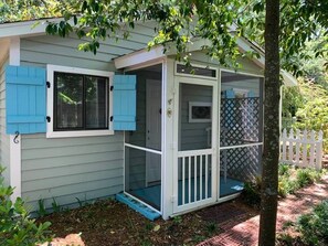 The little back screen porch is where you'll find your beach chairs and cooler.