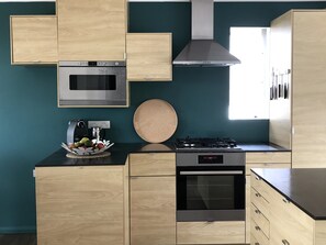 kitchen offering all facilities,  including wide sliding doors onto back deck