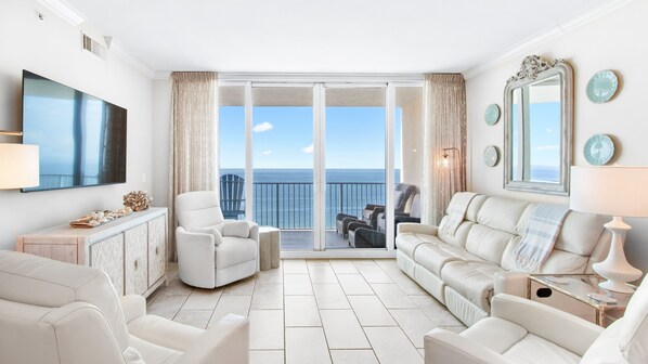 Panoramic oceanfront living room with balcony in luxury Gulf Shores condo