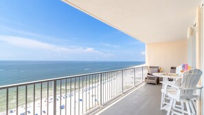 Oceanfront balcony with outdoor seating and sweeping Gulf Shores beach views