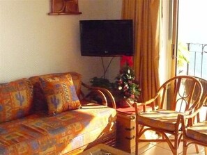 living room with TV, by balcony
