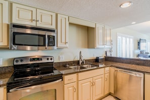 Updated kitchen with granite countertops and stainless steel appliances