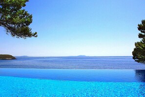 Pool hugged tight by the Mediterranean Sea