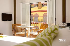 Breakfast table, flat-screen TV and a large window overlooking Feria street.